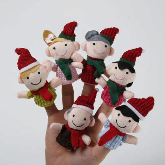 Set of six knitted finger puppets in Christmas-themed outfits on a hand against a white background.