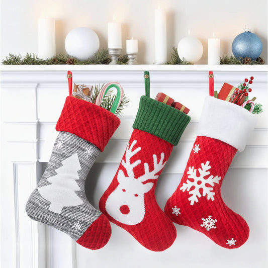 Three Christmas stockings with festive designs hanging on a fireplace mantle.