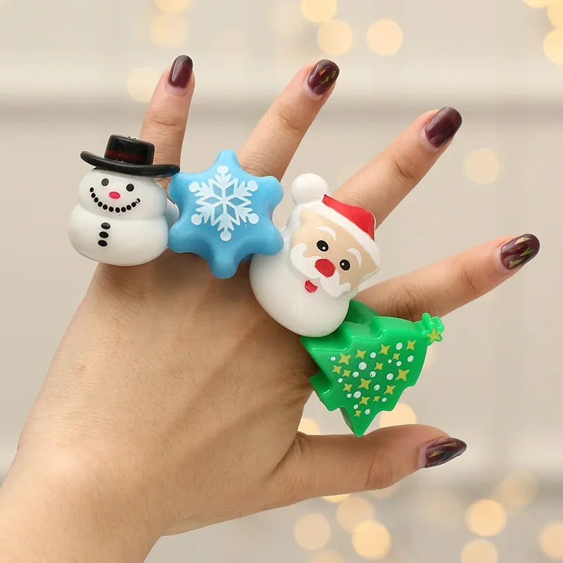 Hand wearing a bracelet with Christmas-themed charms against a blurred background