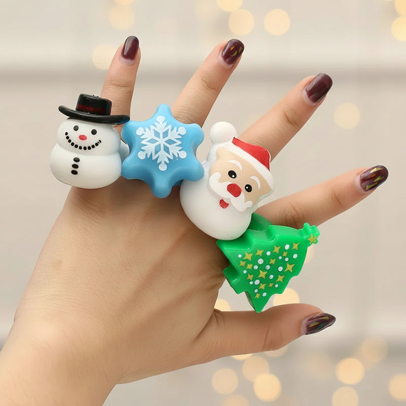 Hand wearing a bracelet with Christmas-themed charms against a blurred background